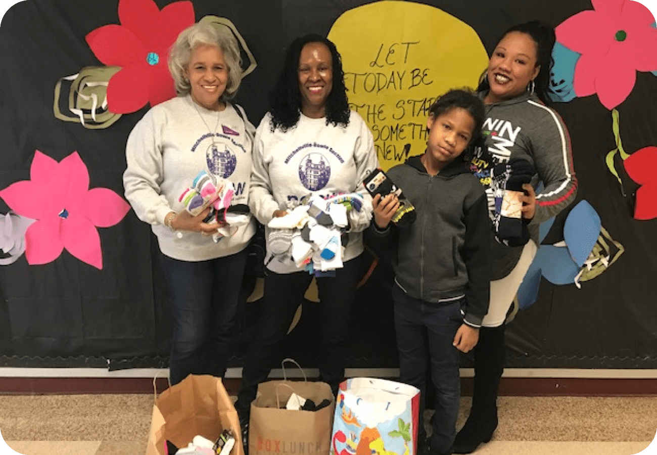 A group of people holding up boxes with toys.