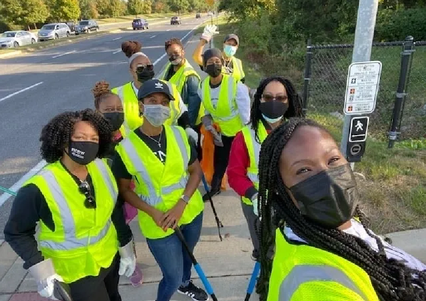 A group of people in yellow vests and masks.